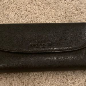Black pebbled leather COACH wallet.